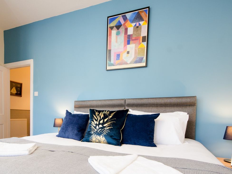 A bedroom with a bed and art on the wall at 46 Ashville Avenue in Scarborough