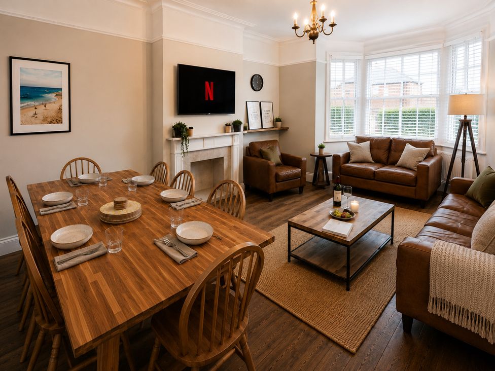 A dining room with a table set and a sofa area at 46 Ashville Avenue Scarborough