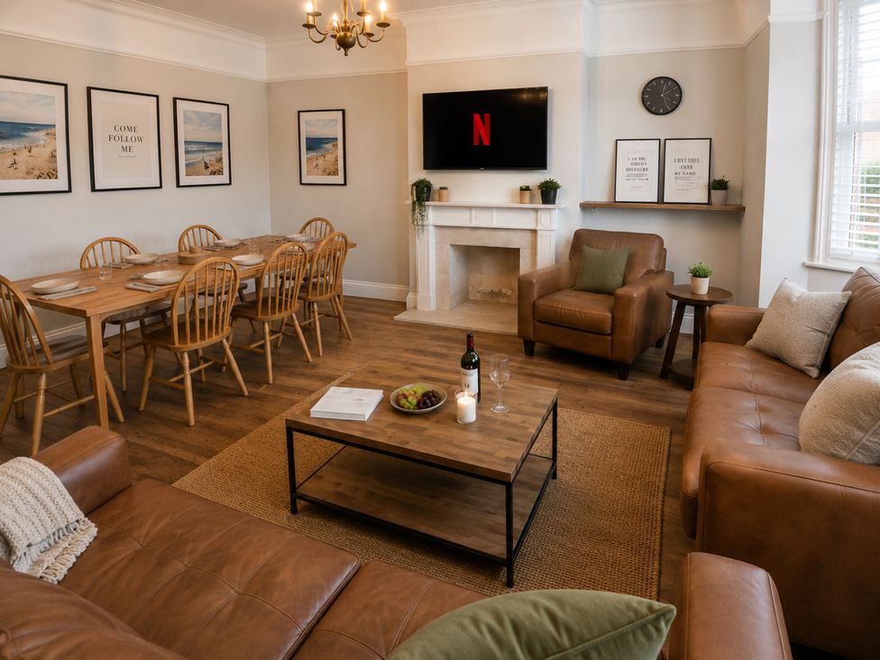 A living room with a dining area and a television at 46 Ashville Avenue in Scarborough
