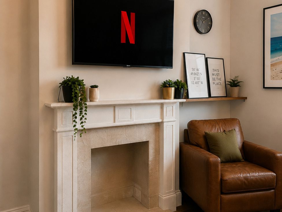 A living room with a fireplace and television at 46 Ashville Avenue, Scarborough