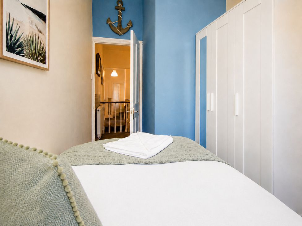 A bedroom with a bed and wardrobe at 46 Ashville Avenue, Scarborough