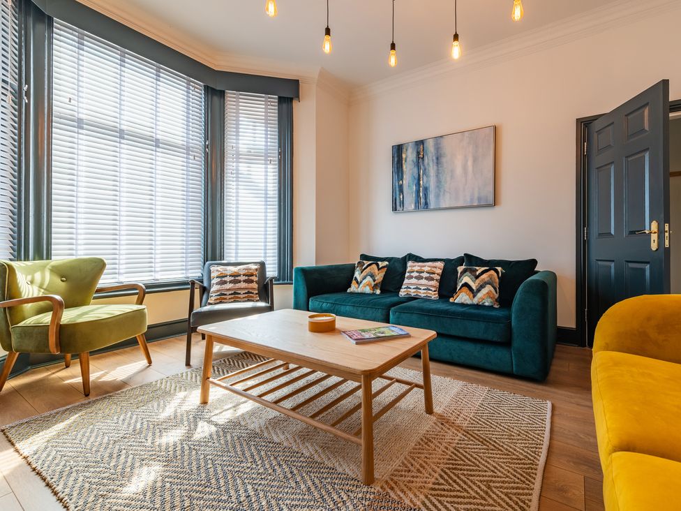 A living room with a sofa and coffee table at 22 Ashville Avenue in Scarborough