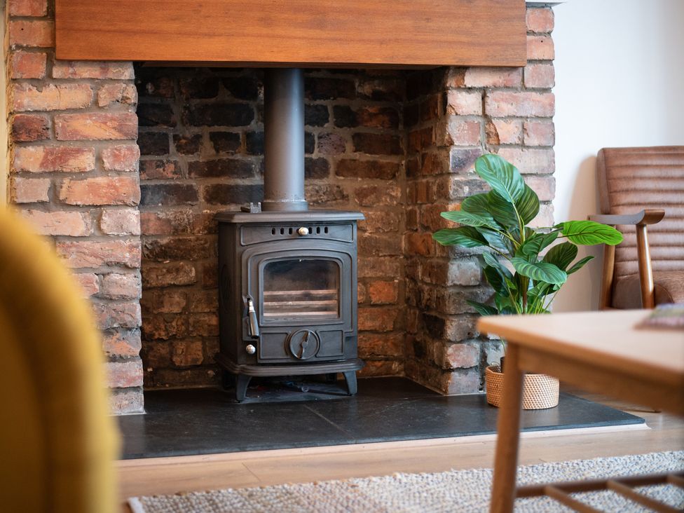A living room with a stove and plant at 22 Ashville Avenue in Scarborough