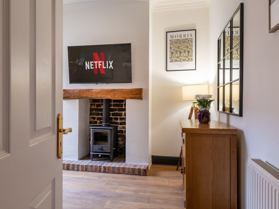 A living room with a TV mounted above a fireplace at 22 Ashville Avenue in Scarborough