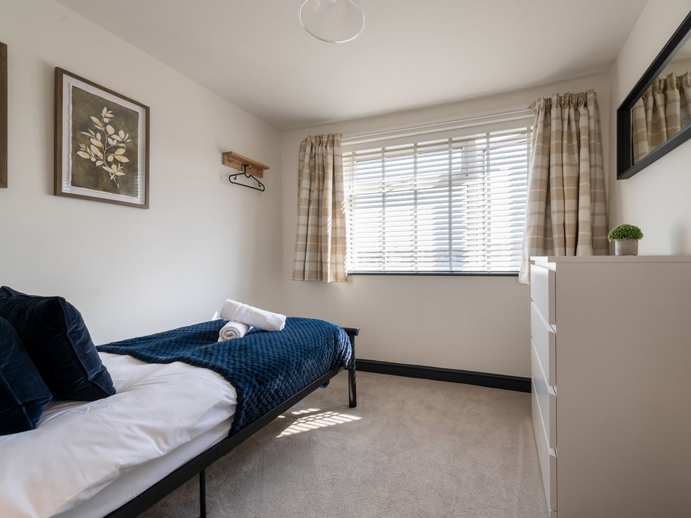 A bedroom with a bed and dresser at 22 Ashville Avenue in Scarborough
