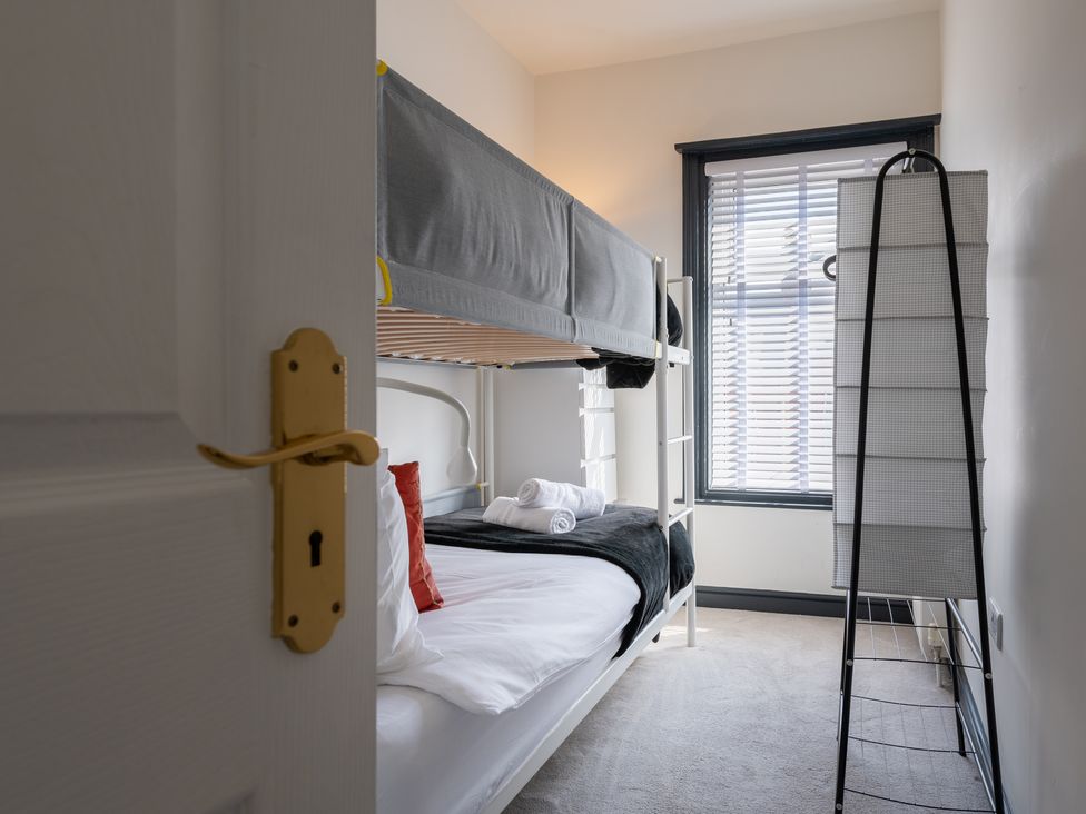 A bedroom with a bunk bed and window at 22 Ashville Avenue in Scarborough