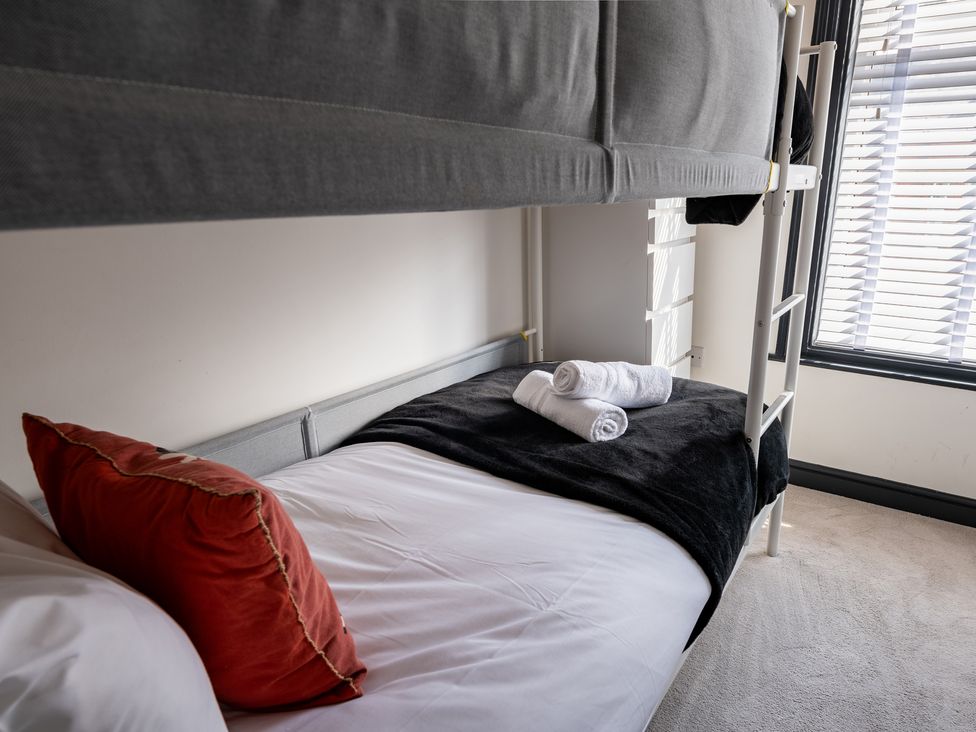 A bedroom with a bunk bed and a twin bed at 22 Ashville Avenue Scarborough