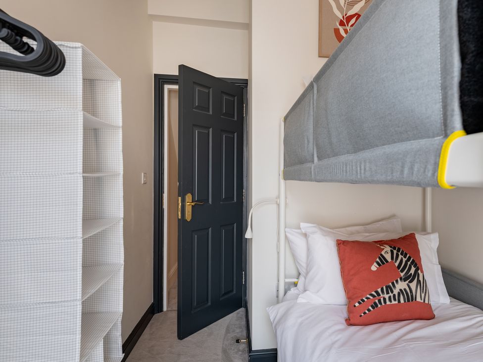 A bedroom with a bunk bed and storage shelf at 22 Ashville Avenue, Scarborough