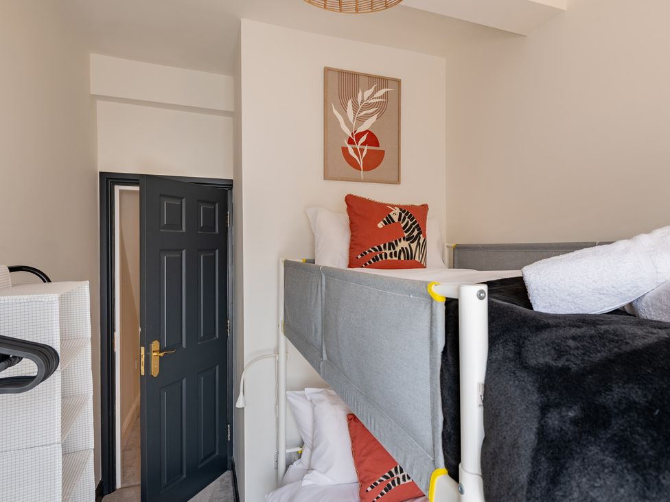 A bedroom with a bunk bed and wall art at 22 Ashville Avenue in Scarborough
