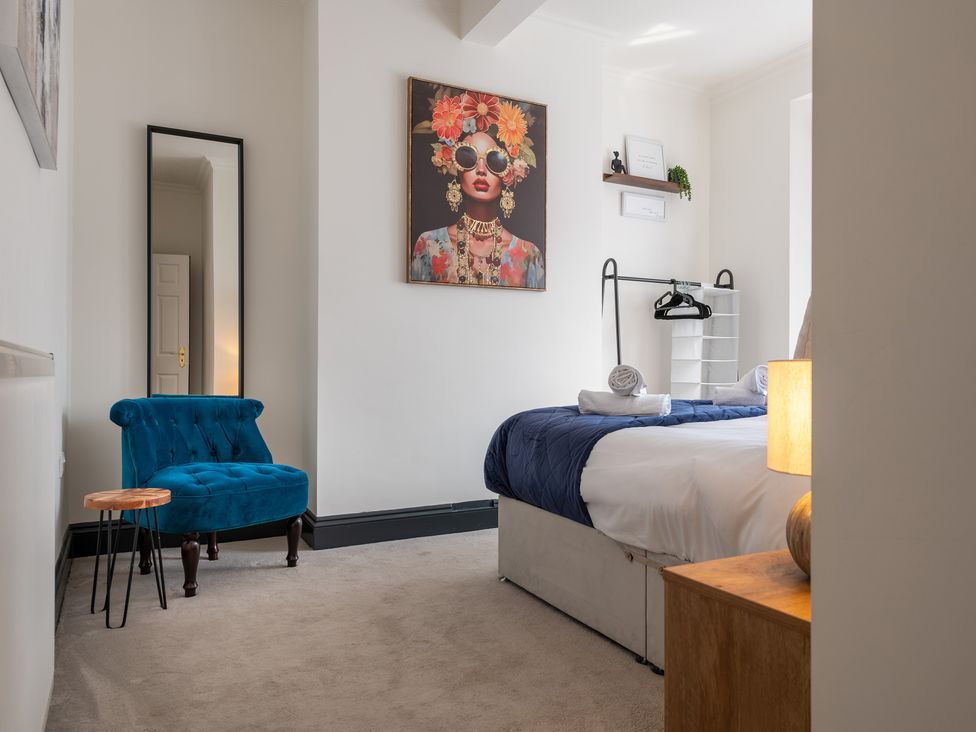 A bedroom with a bed and a chair at 22 Ashville Avenue, Scarborough