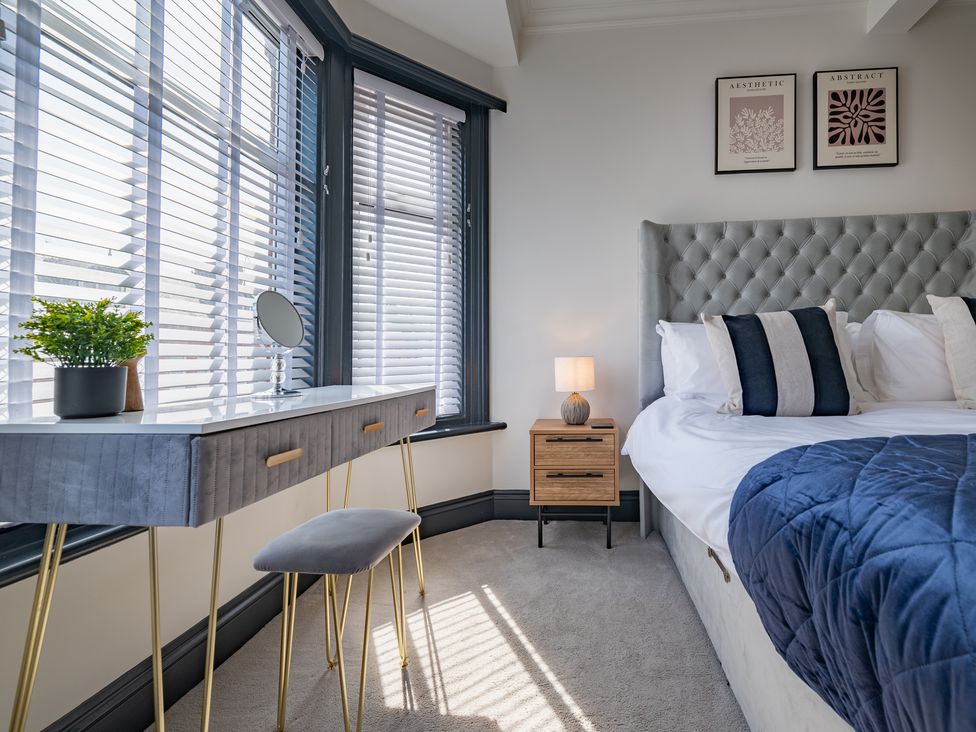 A bedroom with a bed and a desk at 22 Ashville Avenue in Scarborough