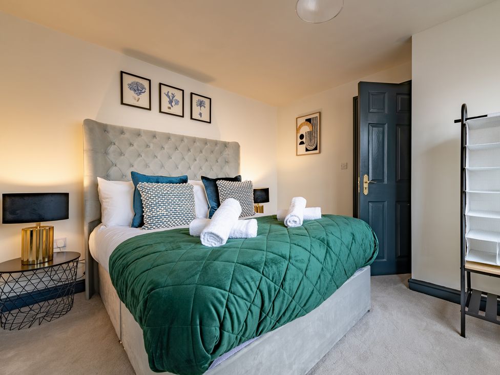 A bedroom with a bed and artwork at 22 Ashville Avenue Scarborough