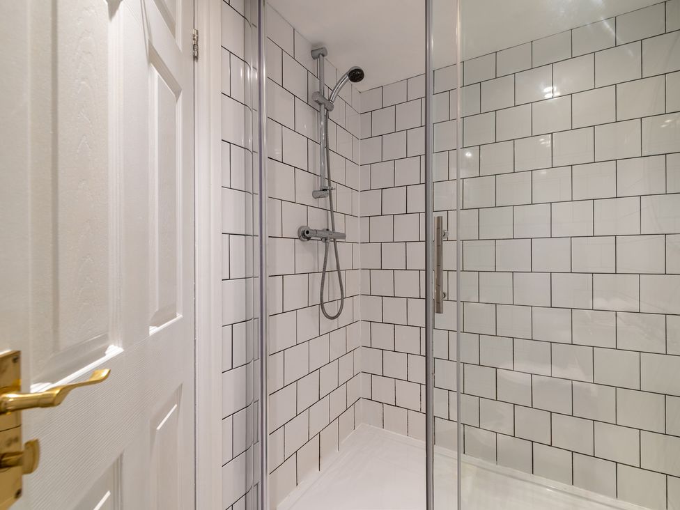 A shower with glass door in a bathroom at 22 Ashville Avenue Scarborough