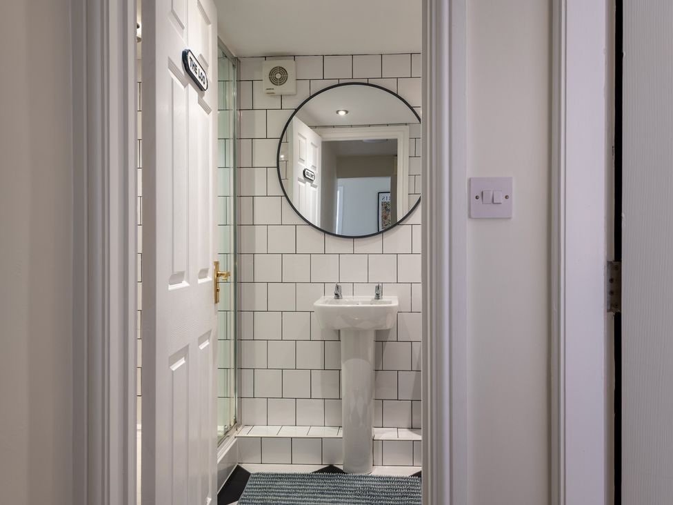 A bathroom featuring a circular mirror and a sink at 22 Ashville Avenue in Scarborough
