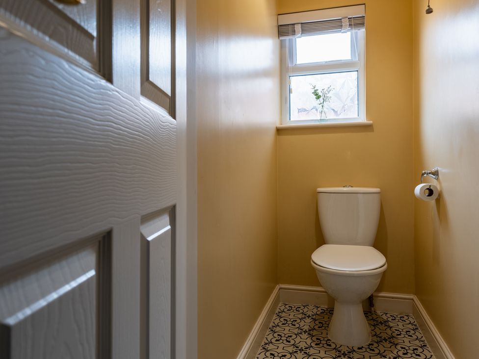 A bathroom with a toilet and window at 22 Ashville Avenue in Scarborough