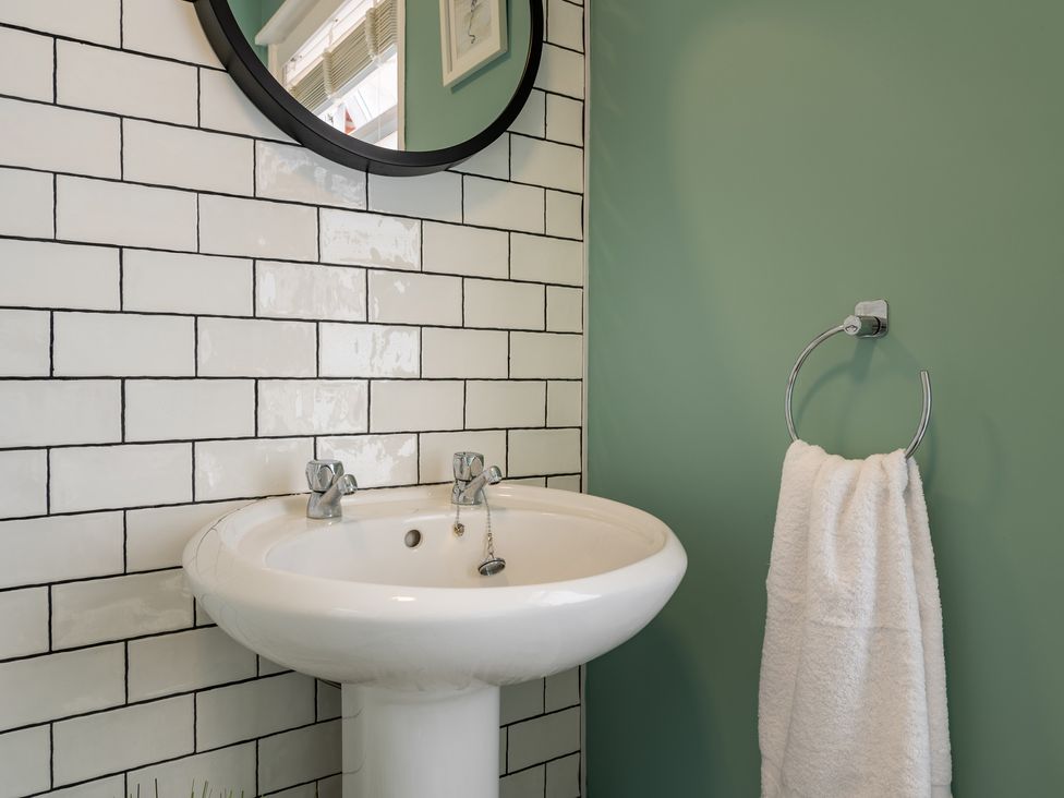 A bathroom with a sink and mirror at 22 Ashville Avenue, Scarborough