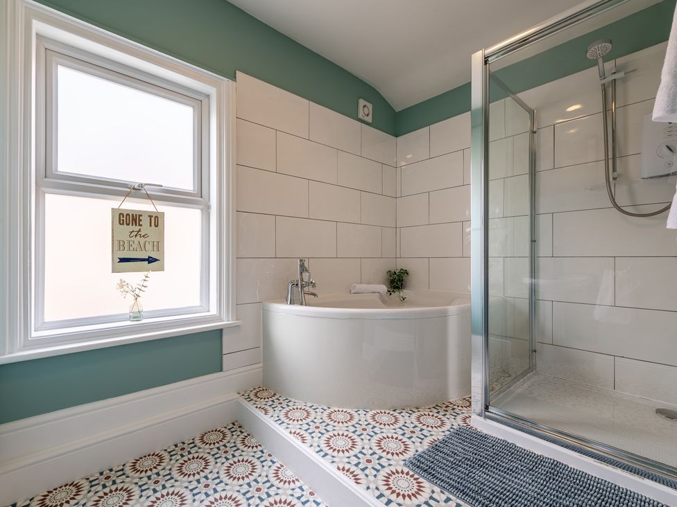 A bathroom with a bathtub and shower at 22 Ashville Avenue, Scarborough