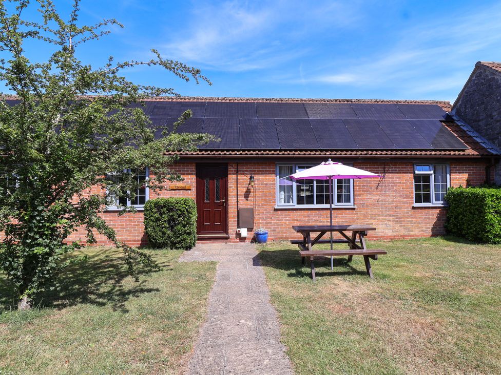 An exterior view of a house with a picnic table and solar panels at Chestnut in Weston-super-Mare
