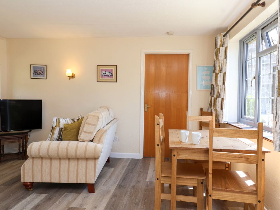 A living room with a sofa and dining table at Chestnut in Weston-super-Mare