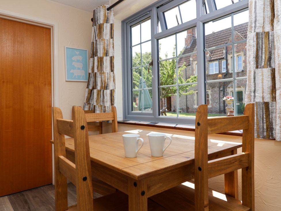 A dining room with a wooden table and chairs at Chestnut in Weston-super-Mare