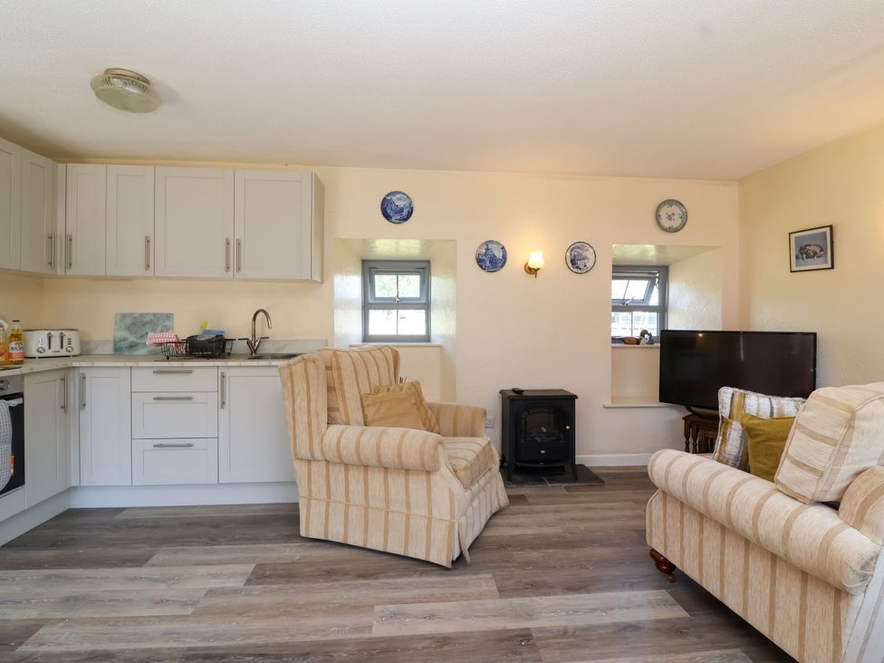 A kitchen and living room area with furniture at Chestnut in Weston-super-Mare