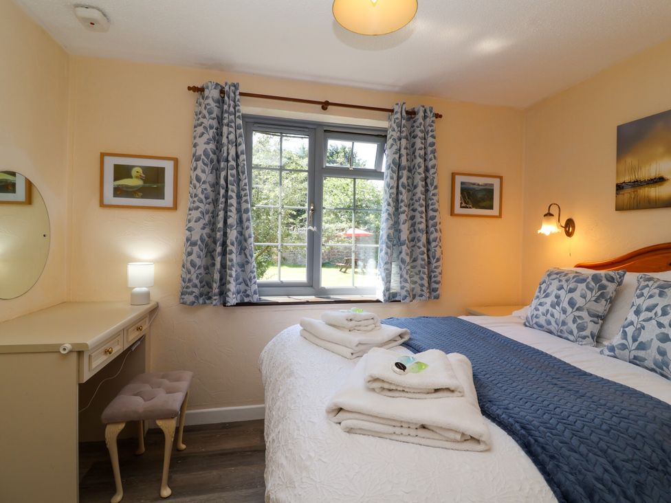 A bedroom with a bed and lamp at Chestnut in Weston-super-Mare
