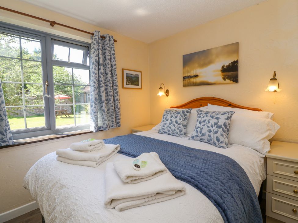 A bedroom with a bed and decorative pillows at Chestnut in Weston-super-Mare