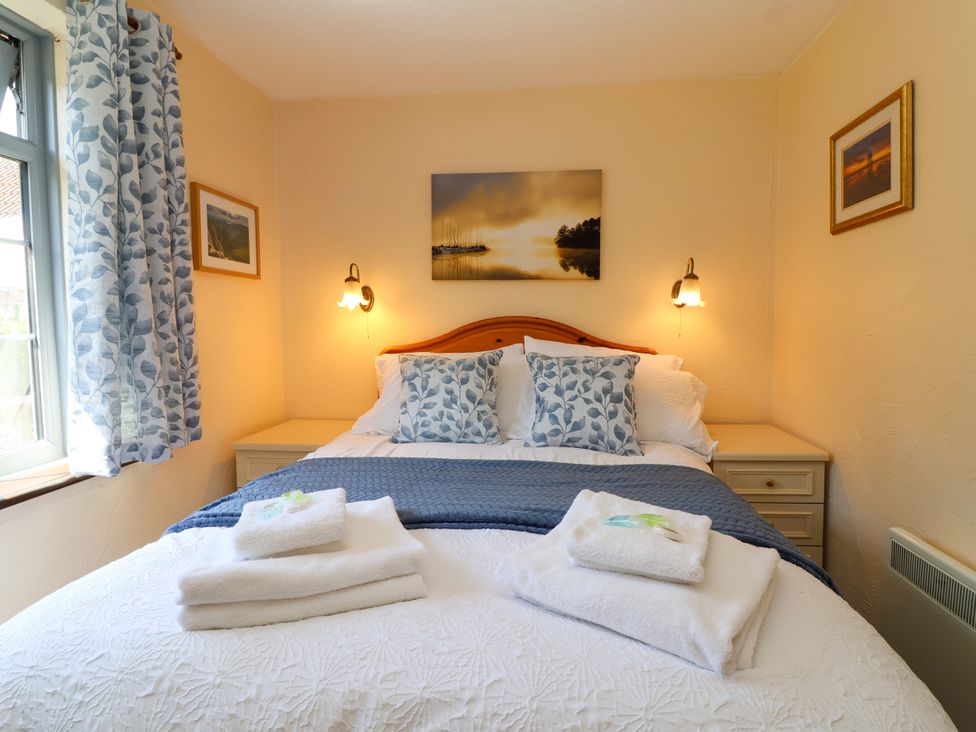 A bedroom with a bed and nightstand at Chestnut in Weston-super-Mare