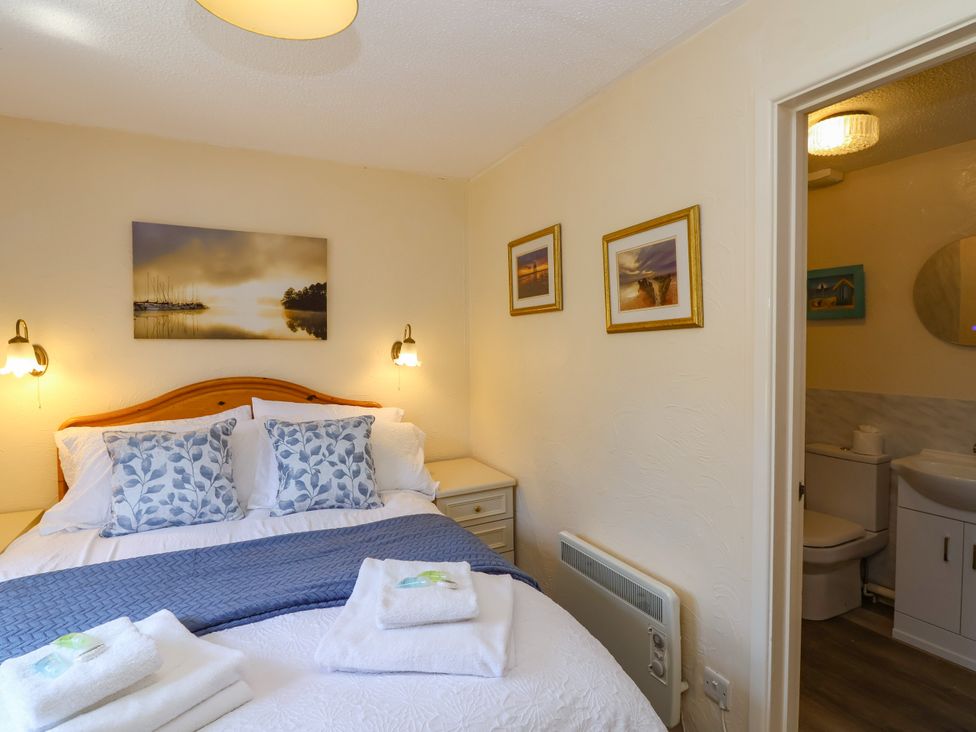 A bedroom with a bed and a bathroom at Chestnut in Weston-super-Mare