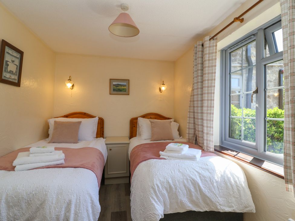 A bedroom with two beds and a window at Chestnut in Weston-super-Mare