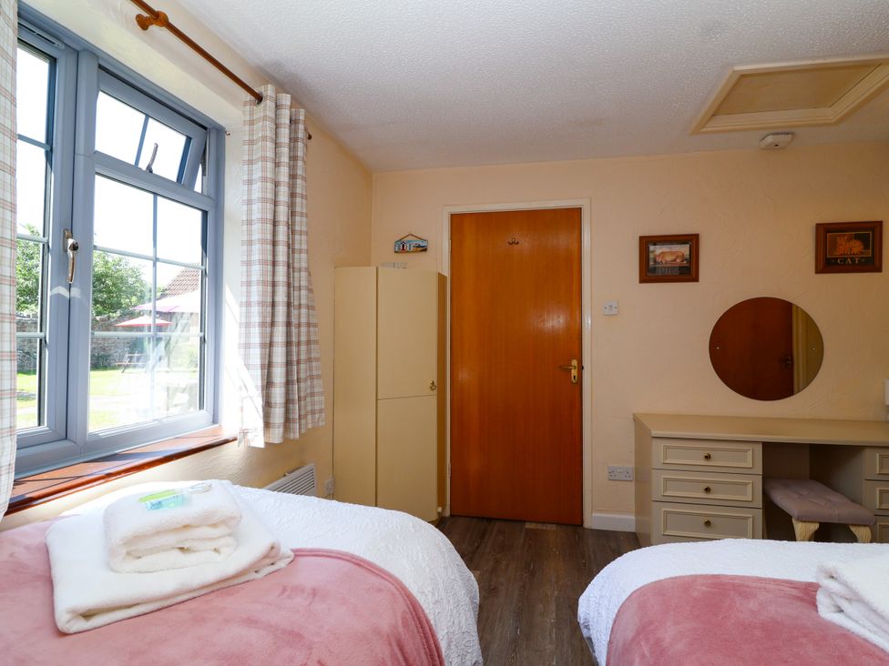 A bedroom with beds and a desk at Chestnut in Weston-super-Mare
