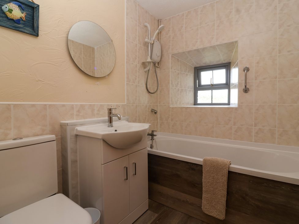 A bathroom with a sink and bathtub at Chestnut in Weston-super-Mare