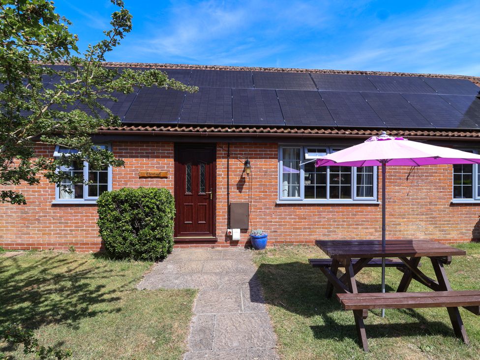 A house with solar panels and outdoor furniture at Chestnut in Weston-super-Mare