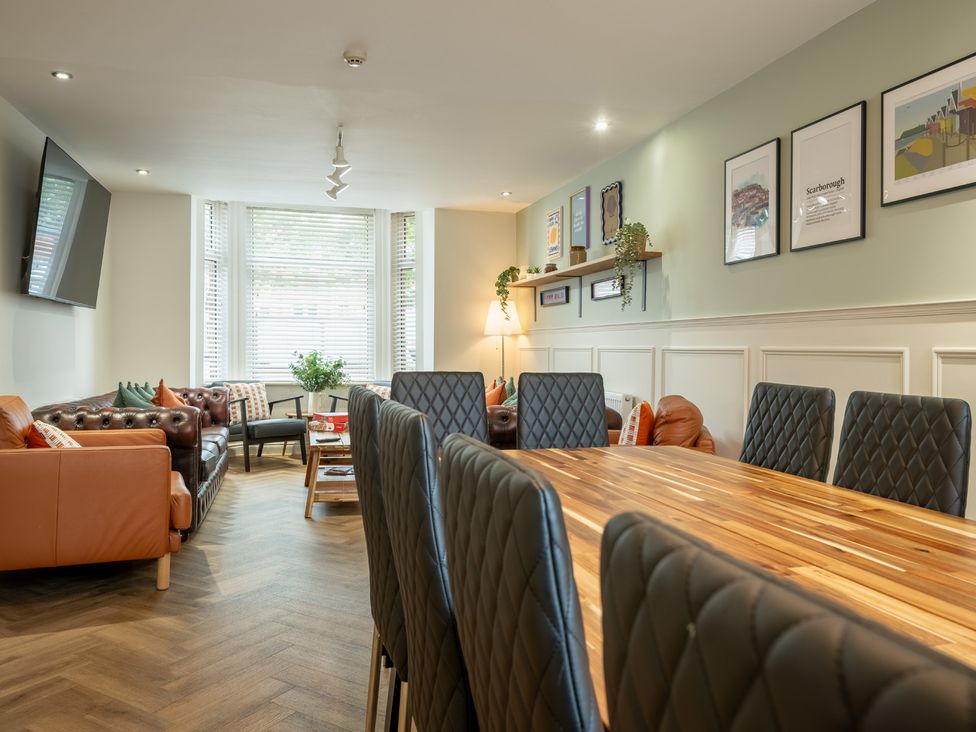 A dining room with a large table and sofas at The Ravines in Scarborough