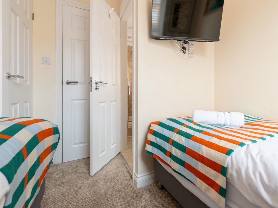 A bedroom with two beds and a television at The Ravines in Scarborough
