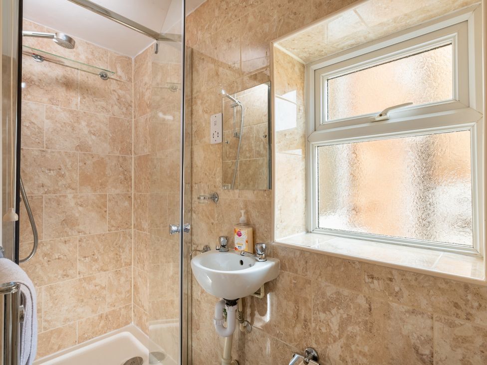 A bathroom with a shower and sink at The Ravines in Scarborough