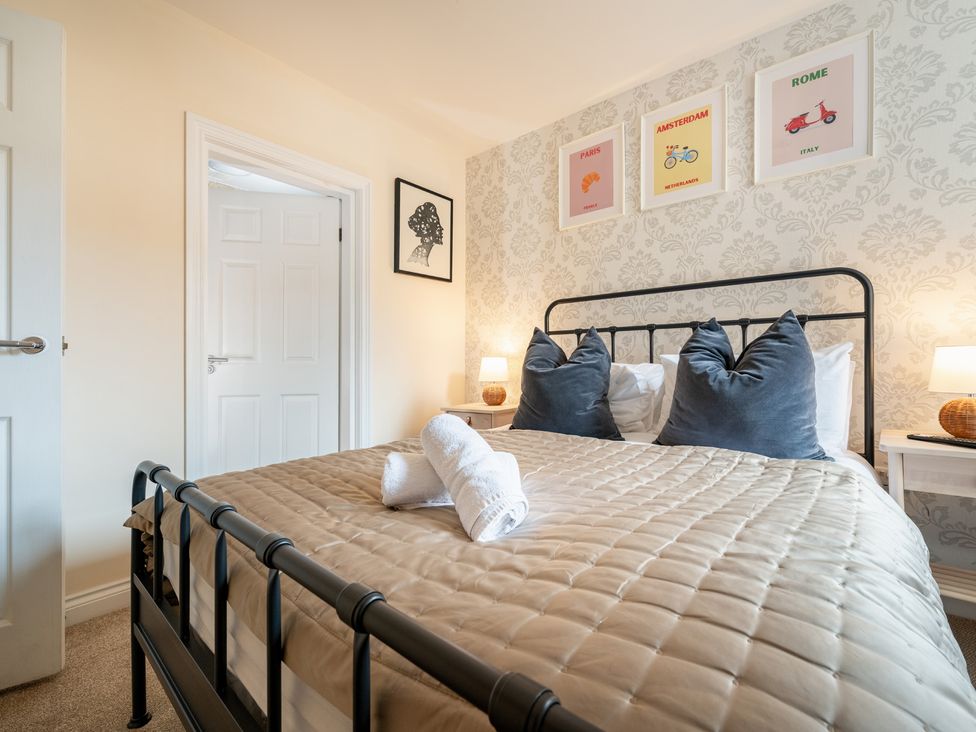 A bedroom with a bed and wall art at The Ravines in Scarborough