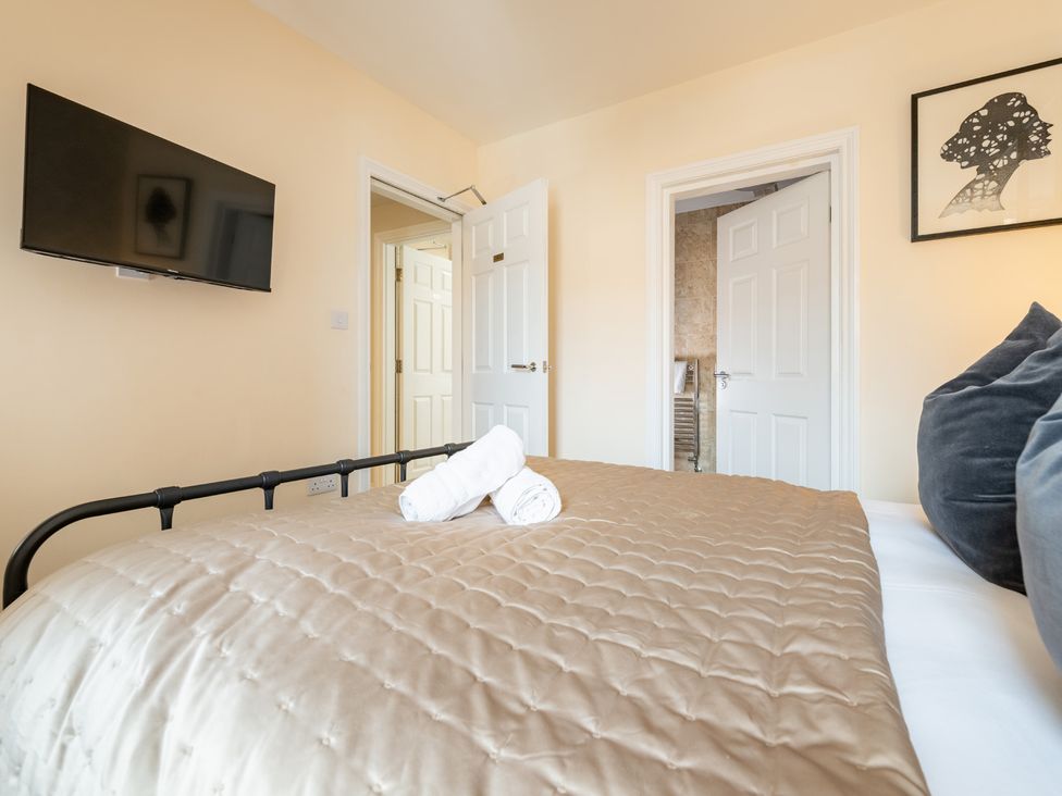 A bedroom with a bed and television at The Ravines in Scarborough