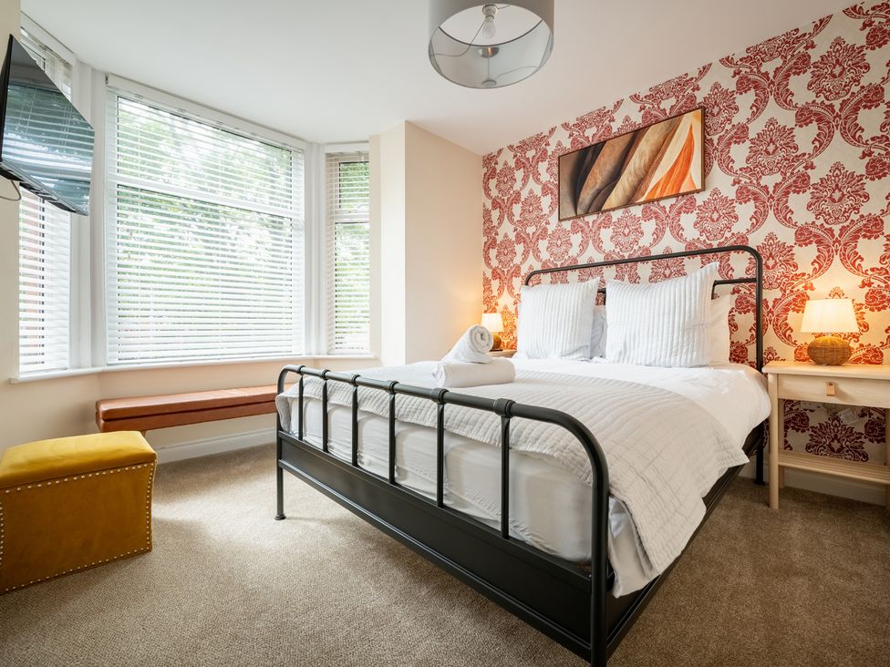 A bedroom with a bed and television at The Ravines in Scarborough