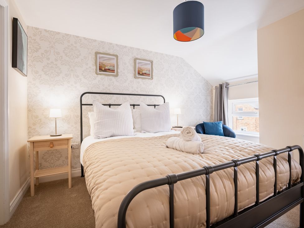 A bedroom with a bed and bedside table at The Ravines in Scarborough
