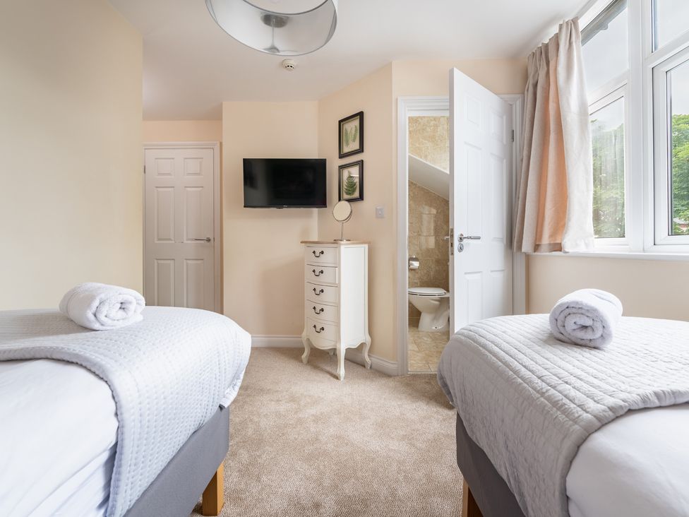 A bedroom with two beds and a television at The Ravines in Scarborough