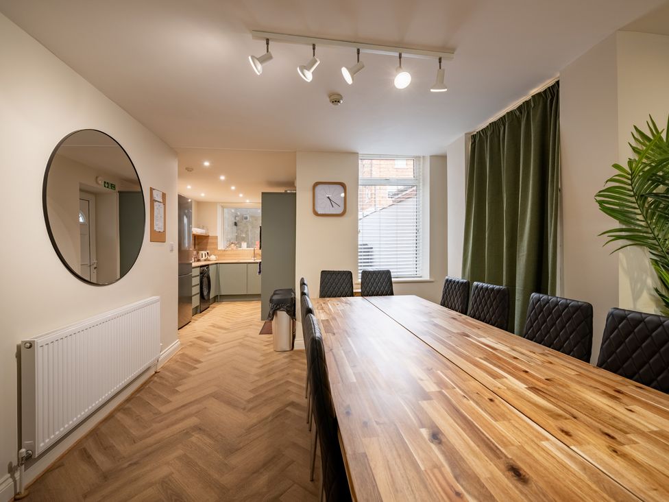 A dining room with a long table and chairs at The Ravines in Scarborough