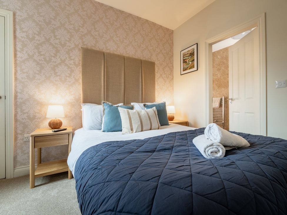 A bedroom with a bed and bedside table at The Ravines in Scarborough
