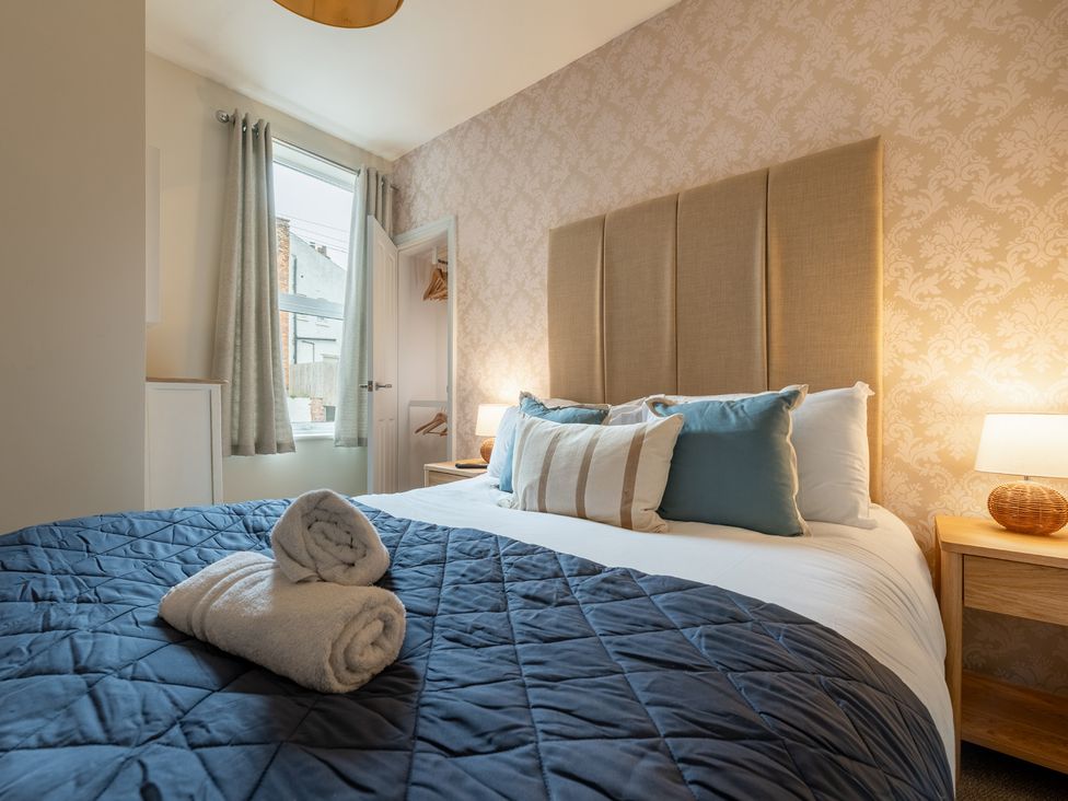 A bedroom with a bed and bedside table at The Ravines in Scarborough