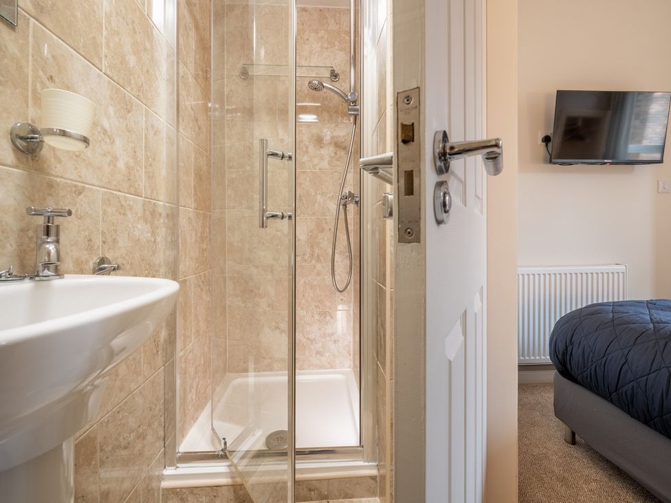 A bathroom with a shower and sink at The Ravines in Scarborough