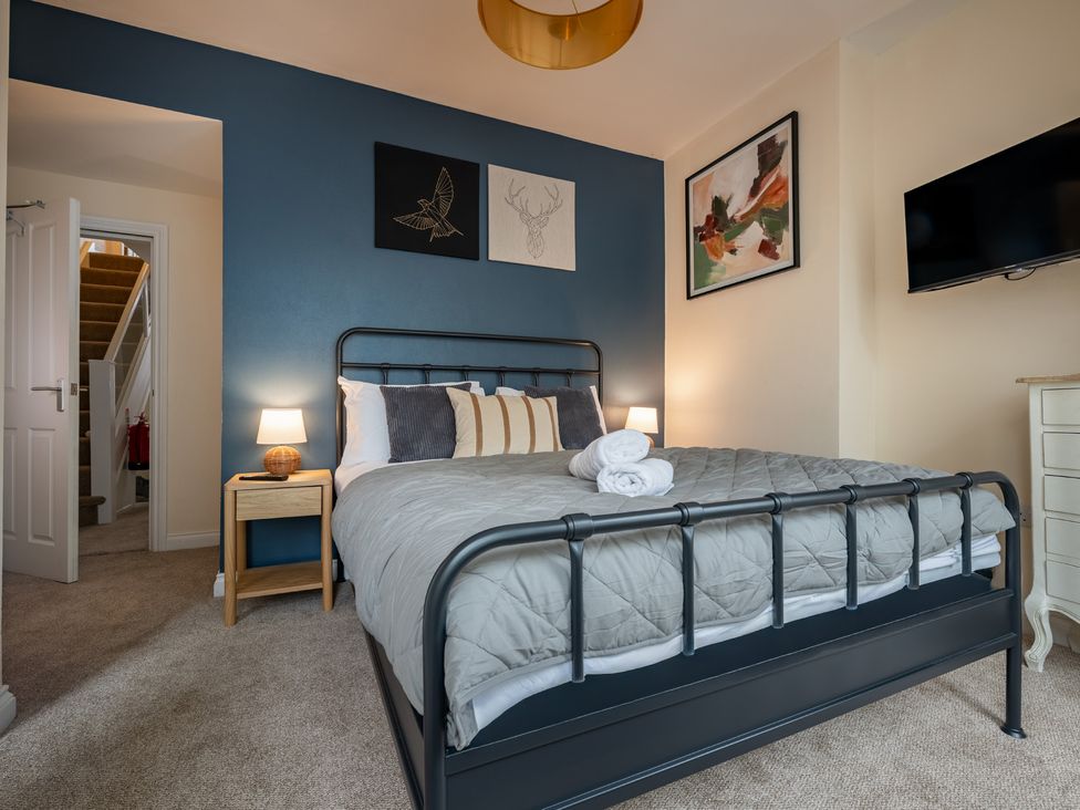 A bedroom with a bed and lamp at The Ravines in Scarborough
