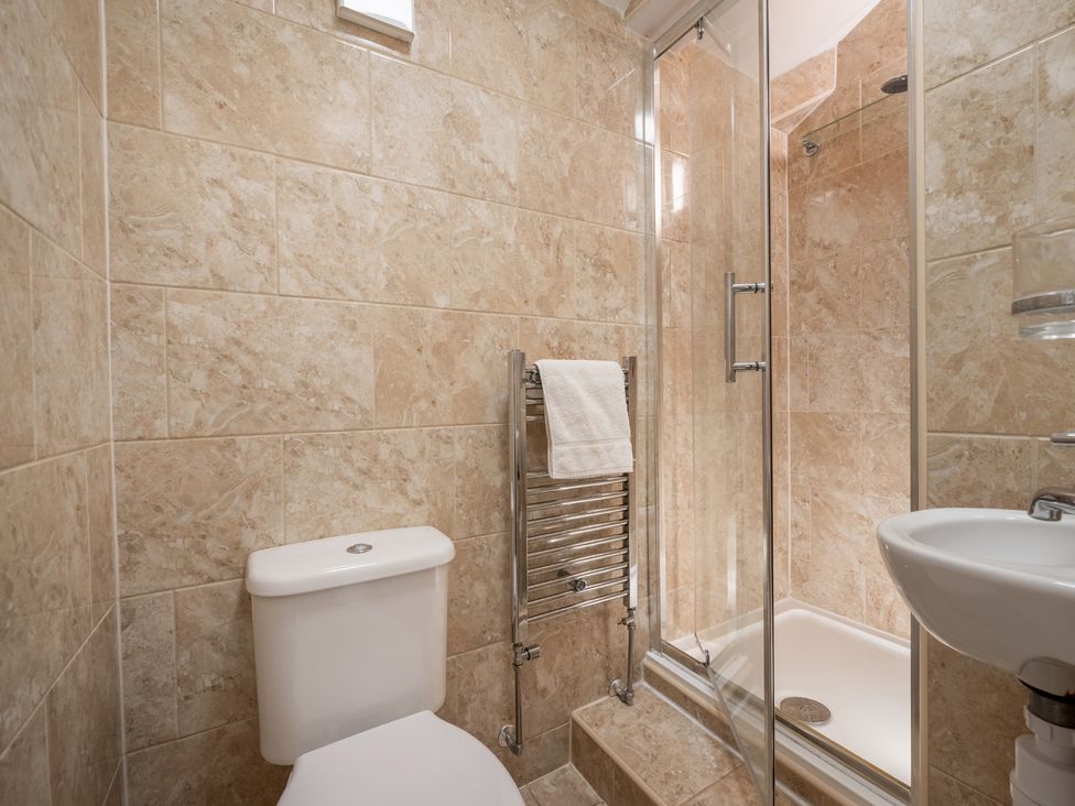 A bathroom with a toilet, shower, and sink at The Ravines in Scarborough