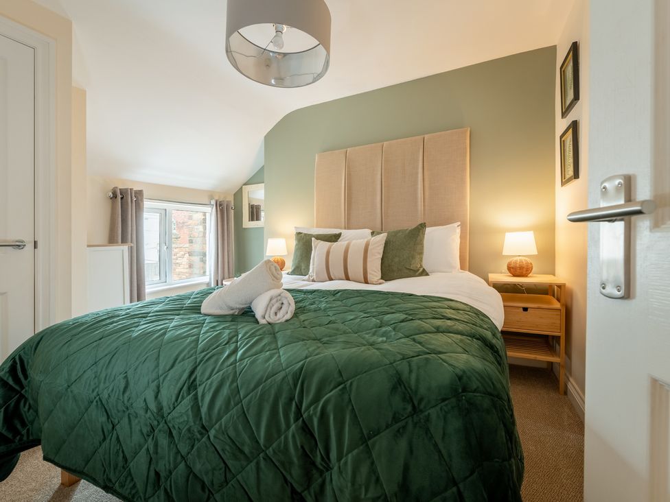 A bedroom with a bed and nightstand at The Ravines in Scarborough
