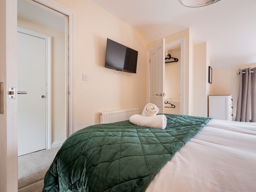A bedroom with a bed and television at The Ravines in Scarborough