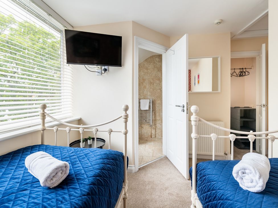 A bedroom with two beds and a television at The Ravines in Scarborough